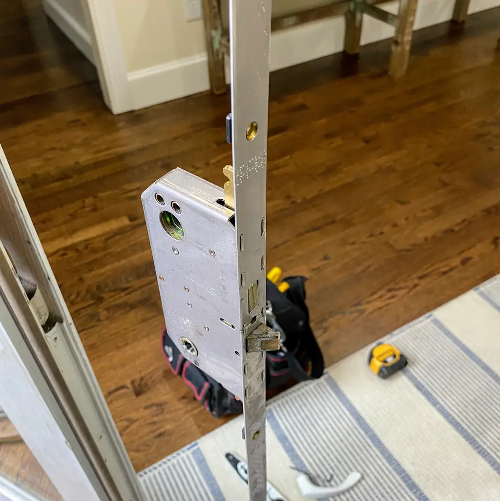 Mortise lock hardware being fitted into a residential door
